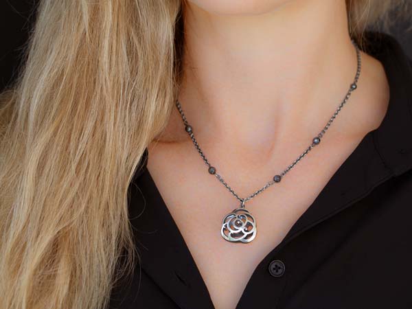 artist wearing bloom pendant